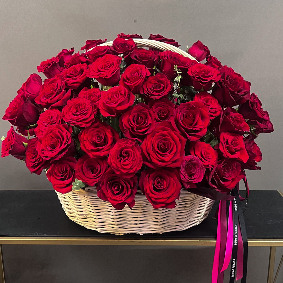100 red roses in a basket