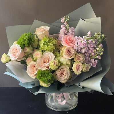 Light pink roses, delicate spray roses, lavender stock, mini green hydrangea, lisianthus