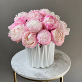 Pink-white peonies in white vase